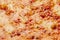 Closeup of browned cheese crust on pizza bolognese with mincemeat and tomato sauce