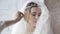 Closeup brunette bride with fashion wedding hairstyle and makeup