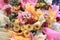 A closeup of a bunch bouquet of artificial flowers at an opening ceremony