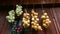 Closeup of bunch of onions Allium cepa drying on wooden background. Harvest time Hanging to dry. Pile of yellow, red onion