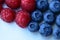 Closeup of a bunch of raspberries and blueberries