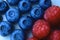 Closeup of a bunch of raspberries and blueberries