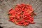 Closeup the bunch red ripe dried chilly in the wooden basket over out of focus brown background