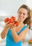 Closeup on bunch of tomato in hand of young woman