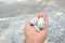 Closeup the bunch white black stone hold hand over out of focus grey brown background