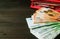 Closeup bunches of Euro banknotes with blurry coins and an opening red wallet in background