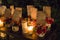 Closeup of burning candles and guests\\\' seating plan cards fixed on the flower pots