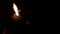 Closeup of a burning oil lamp during the night. Flames in the dark. a lit oil lamp.