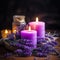 closeup of burning purple candles and dry lavender