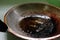 Closeup of burnt, scorched and greasy pan or wok with cooking oil in kitchen.