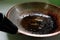 Closeup of burnt, scorched and greasy pan or wok with cooking oil in kitchen.