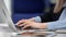 Closeup business female hands inputting data information typing on laptop at hi tech office desk