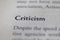 closeup of Business legal term Criticism printed in textbook on white page.