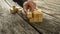 Closeup of businessman assembling blank wooden cubes into a stru