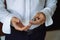 Closeup businessman hands with cufflinks. Man in a business suit, white shirt. Preparing the groom on the wedding day