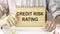 Closeup on businessman holding card with CRR CREDIT RISK RATING acronym text