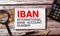 Closeup on businessman holding a card with IBAN INTERNATIONAL BANK ACCOUNT NUMBER