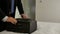 Closeup businessman packing suitcase