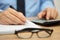 closeup of businessman reviewing financial document and calculating costs