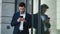 Closeup businessman standing near building. Businessman using smartphone outside