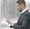 Closeup. businessman with tablet computer standing by the window.