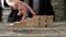 Closeup of businessman walking his fingers up wooden steps