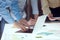 Closeup businessmen hands during business meeting in technology research laboratory. Co-workers gathered around