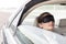 Closeup of businesswoman napping with mask in car