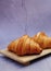 Closeup butter classic croissant on wood plate