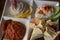 Closeup butter pieces atop bread toasts on plate with meze set of assorted pate and appetizers