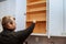 Closeup of a cabinet installer installing hardware on new kitchen cabinets.