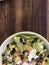 closeup of Caesar salad on a dark wood table