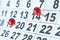 Closeup of the calendar with red pins. Soft focus