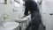 Closeup Camera Move from Hand Wash to Whole Worker in Toilet