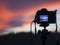 Closeup of a camera on a tripod outdoors. Background Landscape out of focus