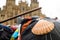 Closeup of camino de santiago scallop shell in front of santiago de compostela cathedral in plaza del obradeiro, with walking