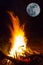 Closeup camp fire under a huge moon