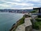 A closeup of a cannon overlooking the harbour in St. John`s newfoundland with the city and harbour in the background.