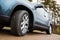 Closeup car fragment, wheel on dirty road