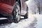 Closeup of car tires in winter on the road covered with snow