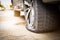 Closeup of car wheel flat tire on the road,car tire leak because of nail pounding on the street waiting for repair or changing