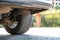 Closeup of a car wheel parked near curb on the side of the street on a parking lot