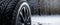 closeup of car winter tire on snowy background. banner