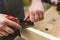 Closeup carpenter planing wood by hand with a planer