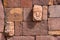 Closeup of a carved stone tenonv head embedded in wall of at the Tiwanaku UNESCO World Heritage Site near La Paz, Bolivia