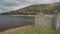 Closeup castle walls ruins at seascape aerial. Historic British palace of Hamilton dynasty on coast