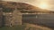 Closeup castle walls ruins at sun seascape aerial. Historic ruined palace on ocean coast