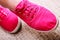 Closeup of casual vibrant pink sneakers shoes boots on female feet