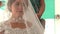 Closeup Caucasian Bride in White Lacy Dress under Veil