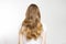 Closeup Caucasian curly wavy hair type back view isolated on white background. Shiny long light brown healthy clean hairstyle.